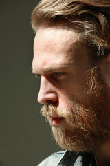 Obraz premium Close-up portrait of hipster man posing outdoor wears denim jacket. Vertical.