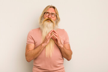 senior cool bearded man scheming and conspiring, thinking devious tricks and cheats, cunning and...