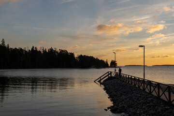 Obraz premium Coastal view of The Saaronniemi, wooden pier, Archipelago Sea and evening sky, Turku, Finland