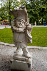 Obraz premium Salzburg, Austria, 28 August 2021: Zwerglgarten or Dwarf Garden in Mirabell palace, Mirabellgarten or Mirabell garden at summer day, was featured in Sound of Music, Famous stone statues on green grass