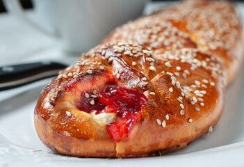 Sweet bread stuffed with strawberry jam and cheese, with sesame seeds, traditional Mexican bread from Oaxaca. Macro photography.