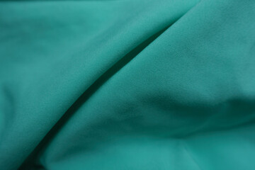 Folded simple thin bluish green chiffon fabric