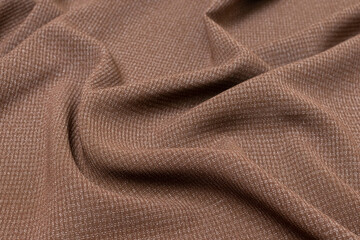 Mauled brown-colored fabric texture background. This fabric is made of cotton and polyester.