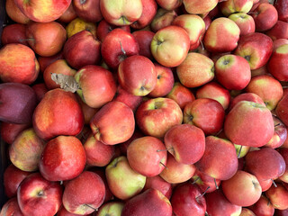 Background of ripe red apples. Texture of apples. Red apples close-up