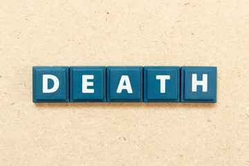 Tile alphabet letter in word death on wood background