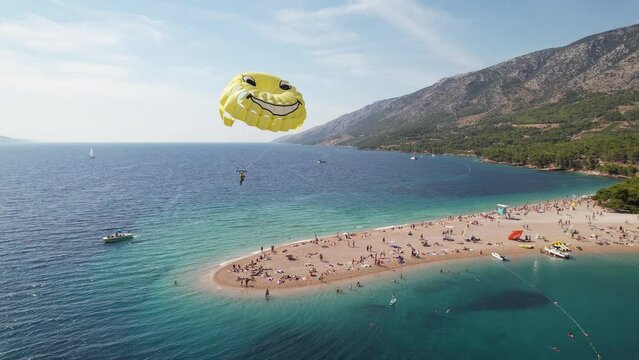 Aerial Break Away Smiley Yellow Parachute Parasailing Over Zlatni Rat Golden Horn Beach Activities Brac Island Croatia Summer Day Drone 4k