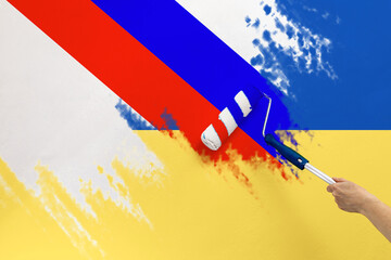 The paint roller puts the flank of Russia on top of the flag of Ukraine. The concept of economic...