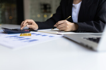 Businesswoman using a calculator to calculate accounting and financial planning. Business woman...