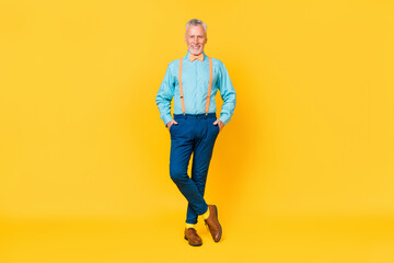 Photo of charming funky guy pensioner dressed teal shirt bowtie bow-tie walking isolated yellow color background
