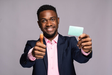 an african man showing a plain card