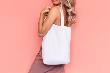 Cropped shot of a young blonde woman with an eco linen bag with empty copy space for text on her...
