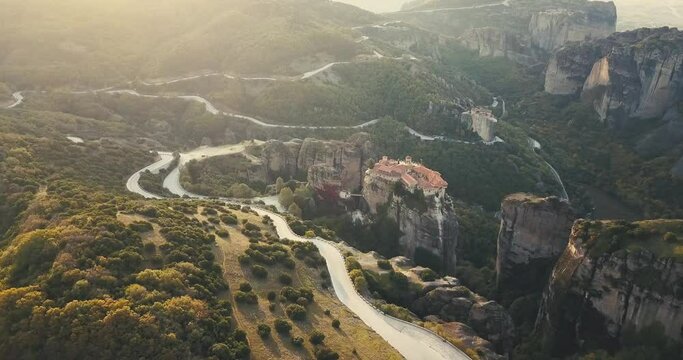 Aerial scenic view of the famous Meteora flying monasteries in Greece at sunrise. A journey to the wonders of the world. Visit tourist attractions and landmarks