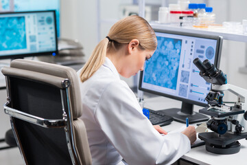 Professional female scientist is working on a vaccine in a modern scientific research laboratory....