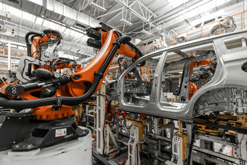 Photo of automobile production line. Welding car body. Modern car assembly plant. Auto industry....