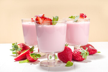 Homemade sweet strawberry panna cotta dessert, pink Italian panna cotta in three glasses, with...