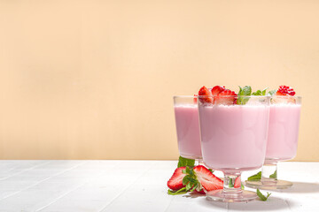 Homemade sweet strawberry panna cotta dessert, pink Italian panna cotta in three glasses, with...