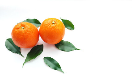 two juicy tasty oranges with green leaves isolated on white background. Source of vitamin C in fruits and vegetables