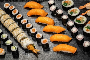 Assorted sushi nigiri and maki big set on slate. A variety of Japanese sushi with tuna, crab,...