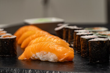 Assorted sushi nigiri and maki big set on slate. A variety of Japanese sushi with tuna, crab,...