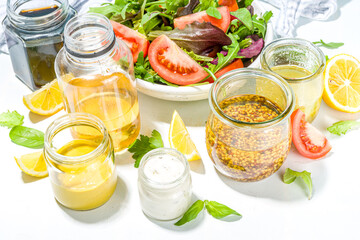 Variety of homemade salad dressings. Set of various salad sauces, oil, vinaigrette, mustard, mayonnaise, ranch, balsamic, soy, yogurt dressings