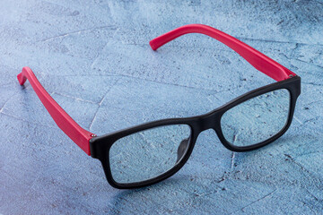 Pair of reading glasses on blue background