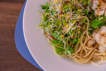 A salad pasta, with small fresh vegetables, chicken and cauliflower