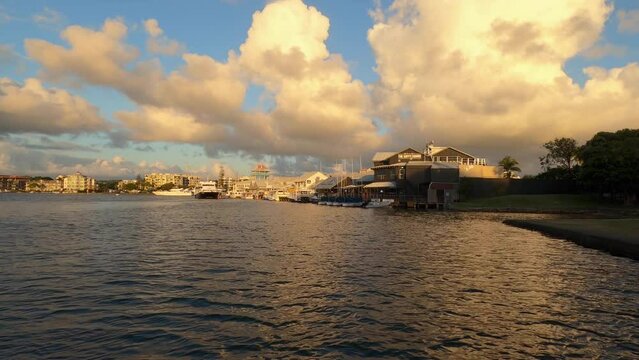 View from over water looking towards Mooloolaba wharf in the distance at dawn. Sunshine Coast Australia.