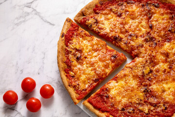 Homemade pizza with Parmesan and Mozzarella cheese and tomato sauce. Flat lay, top view.