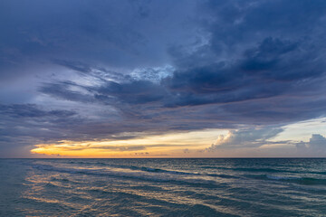 Beautiful sunset on the ocean shore in the evening
