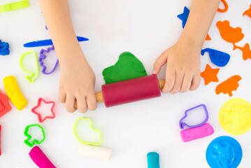 Hands, close-up, top view. Concept of educational games to improve fine motor skills, modeling of...