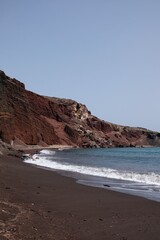 Fototapeta na wymiar Panoramic view of the famous red beach on a windy day in Santorini 