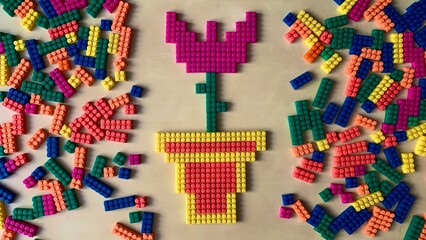 Photo of a purple tulip flower made from a children's constructor using pixel art technology lies...