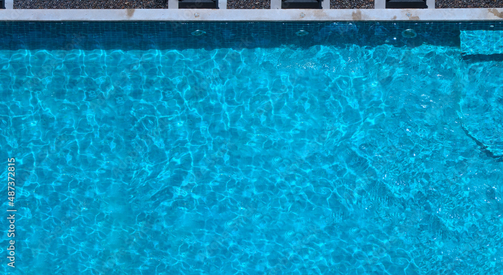 Poster Swimming pool blue water in summer top view angle. Aerial view images of swimming pool in a sunny day which suitable for sport or relax on vacation time or workout for burn some calories in holiday.