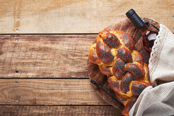 Shabbat Shalom. Bread challah with sesame seeds and poppy seeds on wooden background. Traditional jewish bread for Shabbat and Holidays. Rustic concept. Copy space. Selective focus. - obrazy, fototapety, plakaty