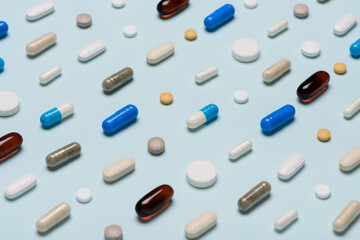 Different pills pattern on blue background.  Assorted medicine drugs.