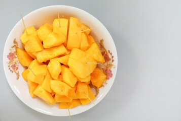 Papaya fruit in dish on white background with copy space