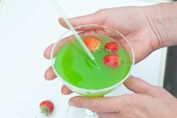 Colorful bright green cocktail cactus with strawberries, delicious refreshing