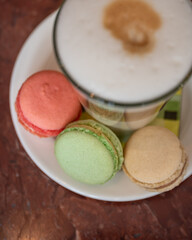 Coffee and cakes. Photo of macaroons and latte macchiato. Coffee time in french coffee. 