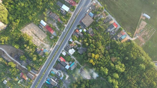 aerial view of road and home,beautiful nature in the morning,shot from top view,still flying
