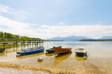 boats at lake Chiemsee with alps in background