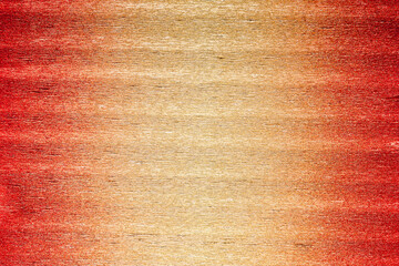 Texture of metallic crepe paper in red, orange and gold color gradient