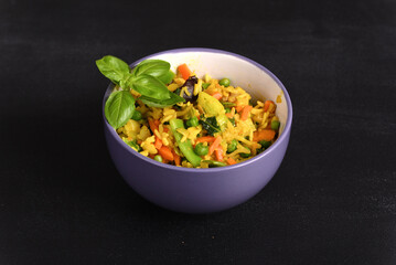 Rice with vegetables and yellow seasoning in a plate.