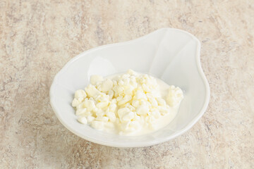 Grained cottage cheese in the bowl