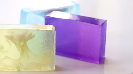 Transparent glycerin bar soap isolated on table, on white background.