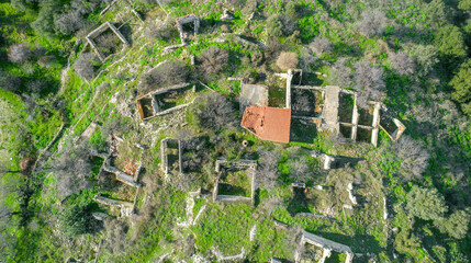 Ruins of traditional stone houses, rural depopulation in Cyprus. Aerial view directly above - obrazy, fototapety, plakaty