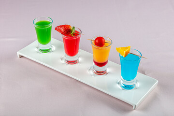 Variety of colorful green blue yellow red and white beautiful alcohol sweet shooters shots cocktail...