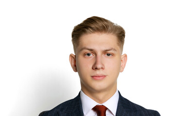 Close-up portrait of handsome young businessman, student, diplomat looking at camera isolated on white studio background. Human emotions, facial expression concept.