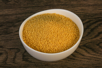 Raw cous cous heap in the bowl