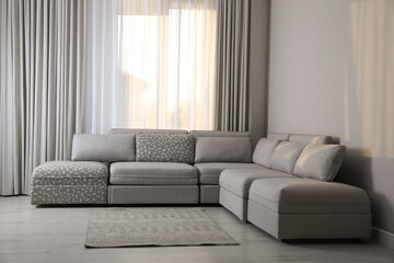 Large grey sofa in living room. Interior design