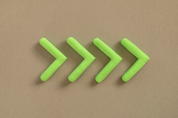 Green arrows pointing right side. Three dimensional arrow sign showing direction on neutral background. Development  concept, go green or heading target metaphor, striving for the goal, going forward.